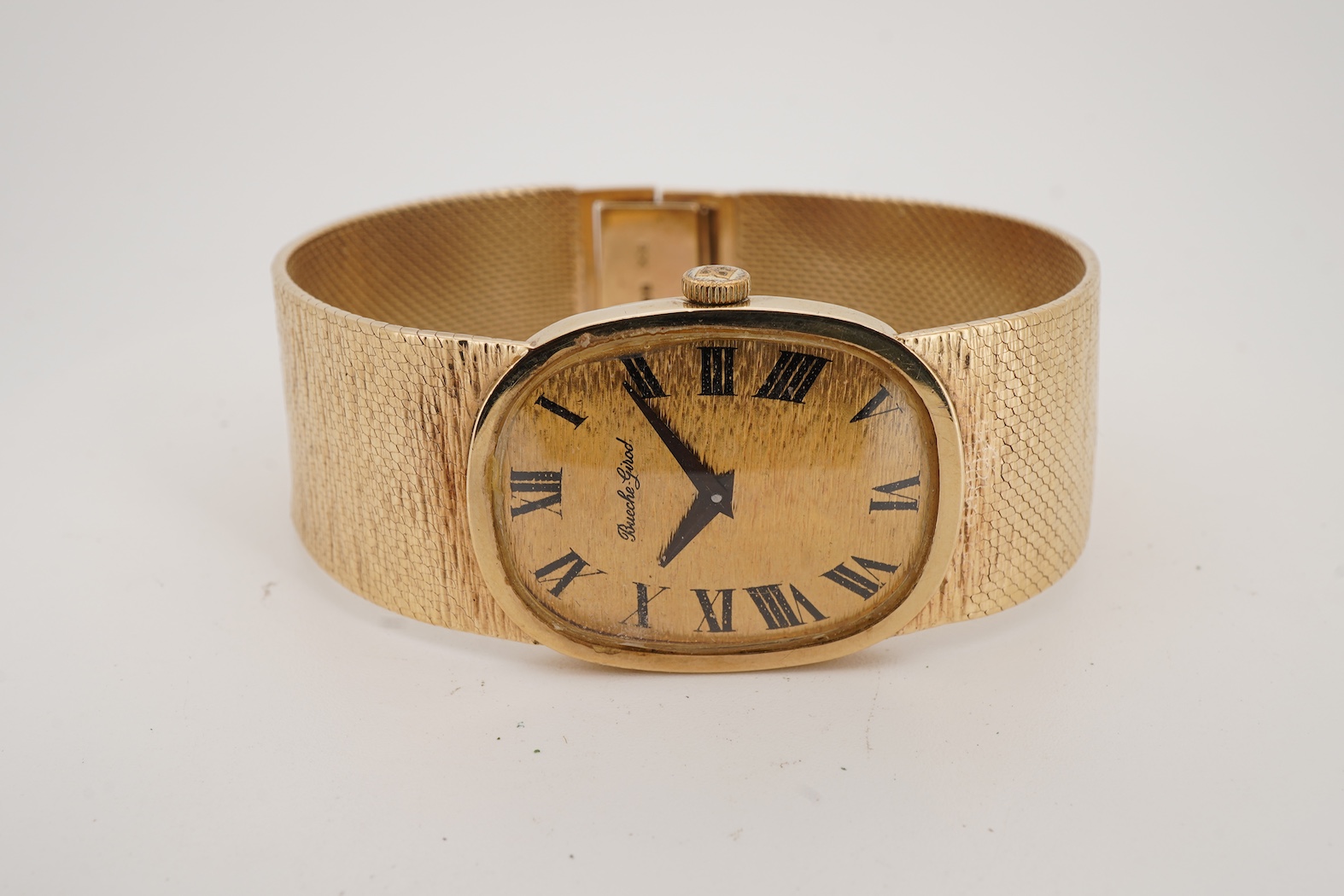 A gentleman's early 1970's 9ct gold Bueche Girod manual wind dress wrist watch, on an integral 9ct gold bark effect bracelet